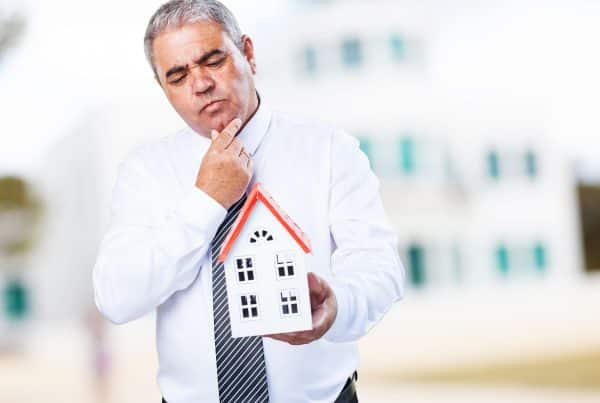 Man holding a small house model.