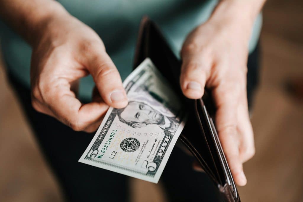 Person holding money from wallet